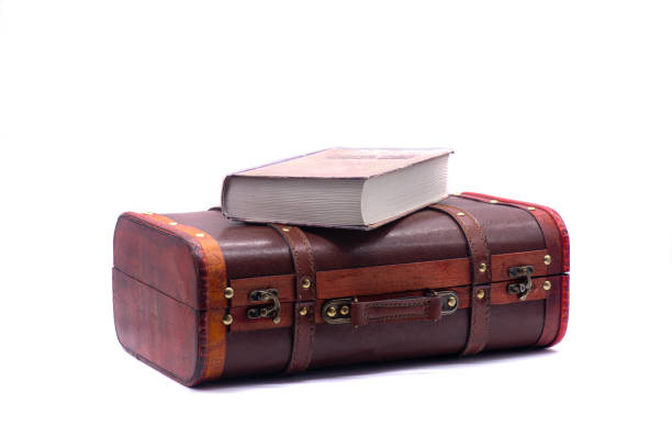 istock Retro suitcase and book on white background 1304316457