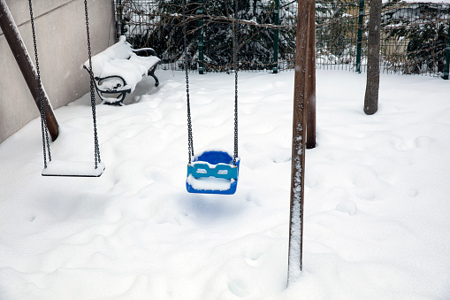 Kid's Playground Covered with Snow with a Toy in a Winter Day