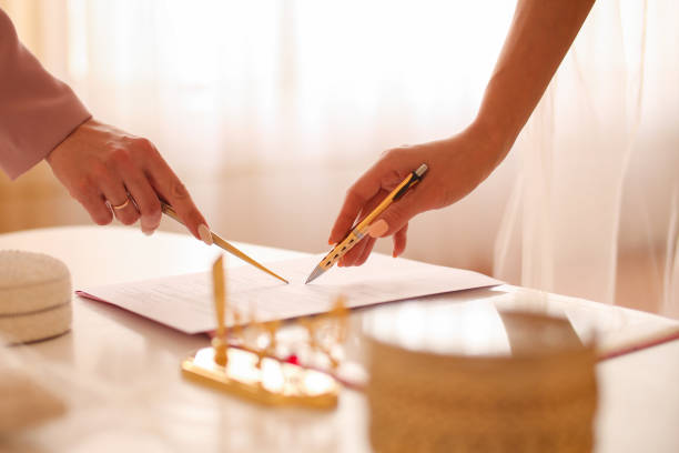 istock Bride signing marriage certificate, signature wedding contract 1304319147