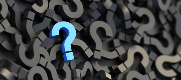 istock Blue question mark on a background of black signs, FAQ Concept 1304325328