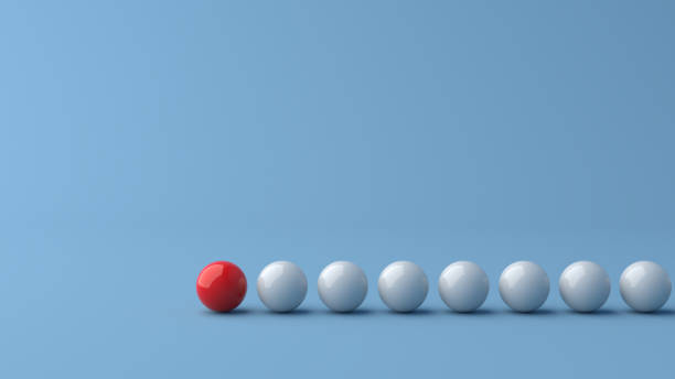 istock Leadership concept, red leader ball leading white balls, on blue background with empty copy space 1304327659