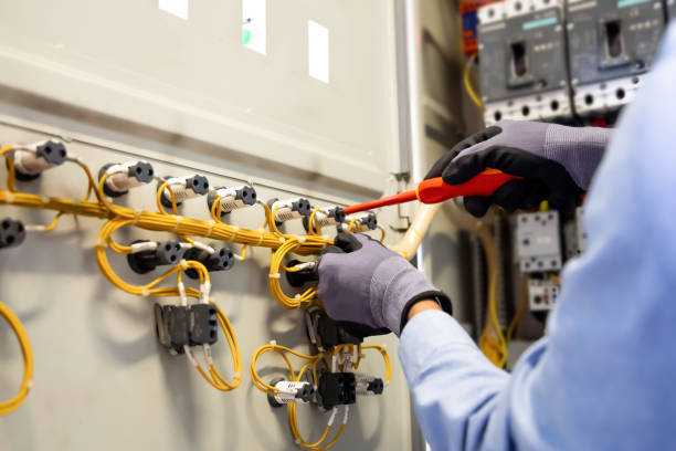istock Electricians work to connect electric wires in the system, switchboard, electrical system in Control cabinet. 1304327809