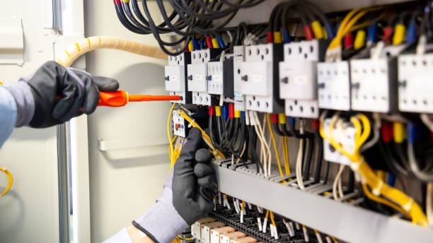 istock Electricians work to connect electric wires in the system, switchboard, electrical system in Control cabinet. 1304327829