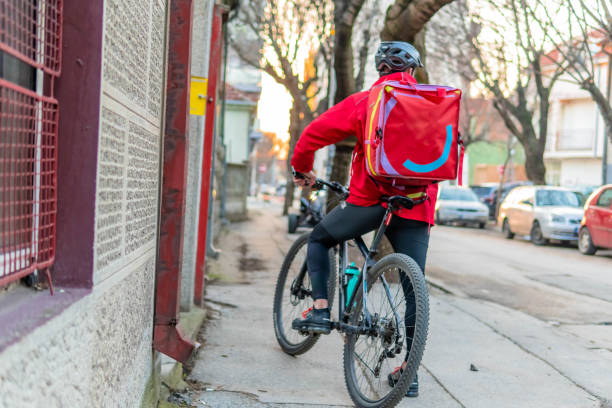 istock Young man working in delivery service. delivery man with bicycle 1304328317