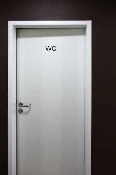 Nondescript bathroom plumbing with a white urinal in men's, boy's bathroom.