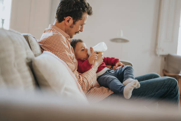 istock Father feeds baby milk from bottle 1304334687