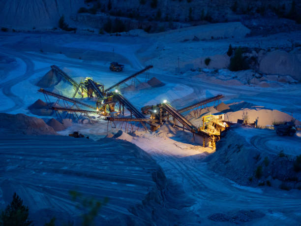 Open cast mine Open cast mine at night with concentrating mill and back-loader open pit mine photos stock pictures, royalty-free photos & images