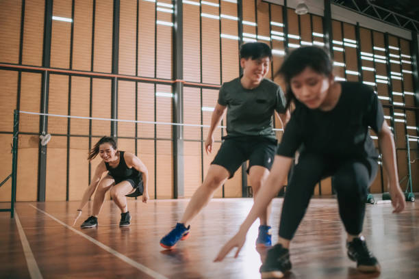 istock Low angle asian chinese badminton players practicing in badminton court endurance training 1304335856