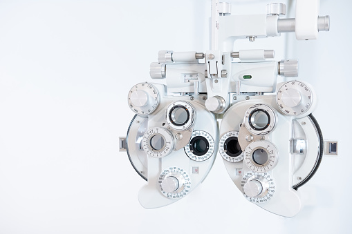 Patient getting an eye exam at the ophthalmologist - healthcare and medicine concepts