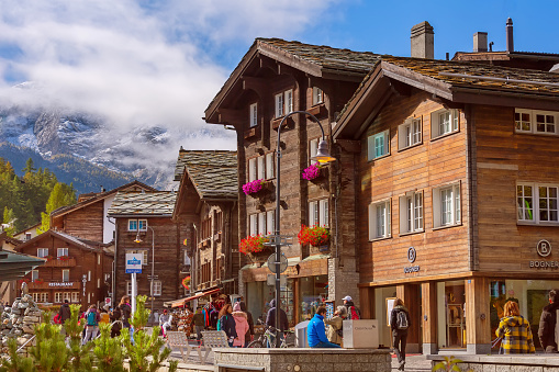 Zermatt, Switzerland - October 7, 2019: Town street view in famous Swiss Alps ski resort, people