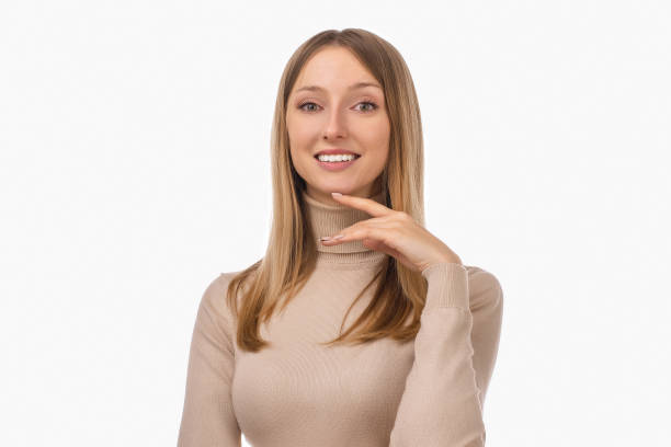 istock Pensive blond girl with thoughtful expression, keeps hand on chin, plans something or makes choice 1304337296
