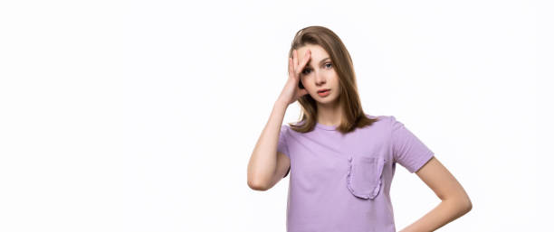 istock Regretful young woman made mistake. Studio shot, white background. Place for your text 1304337311