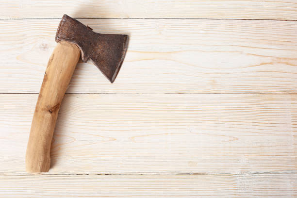 istock Old ax on wooden background top view 1304339270