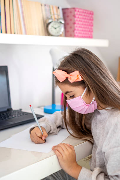 istock Littel girl education with double mask 1304340594