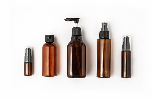 Amber glass cosmetic bottles on white background. Blank label for branding mock-up.