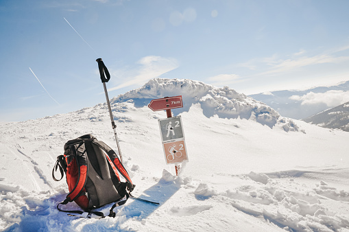 Adult Man Hiker Sitting Next to Directional Signs