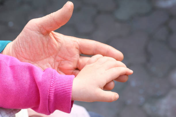 istock Children's hand in an elderly hand 1304345154