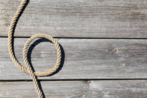 istock Ship rope on old wooden texture background with copy space 1304346153