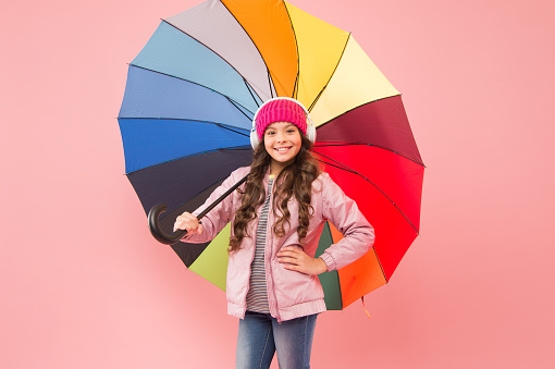 Accessory in case it rains. Small child enjoy music under colorful umbrella rain accessory. Little girl in coat with fashion accessory for rainy autumn season. The perfect accessory to keep her dry.