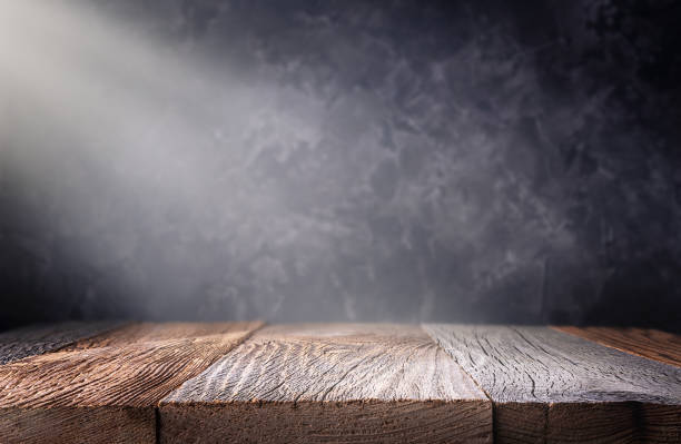 istock Empty wood table top with defocused concrete wall background. 1304348966