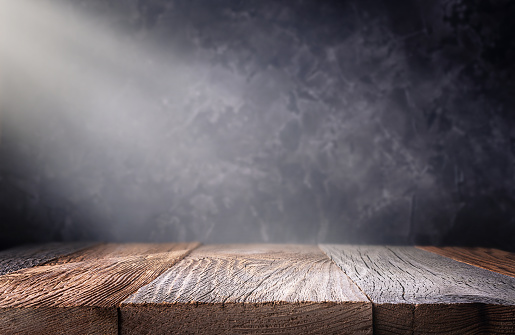 Empty wood table top with defocused concrete wall background. Template for product display.