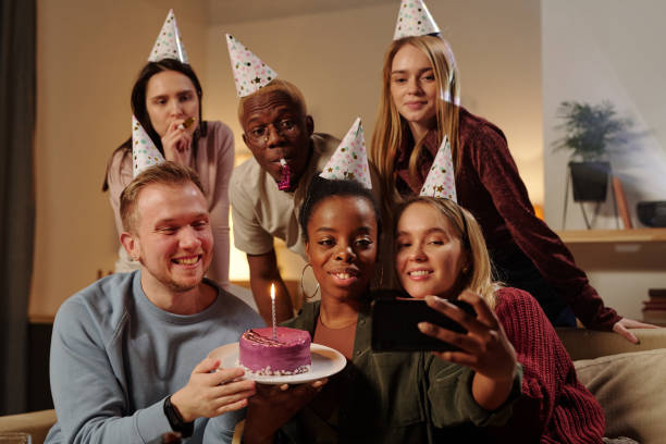 istock Cheerful intercultural friends looking at smartphone camera and making selfie 1304350761
