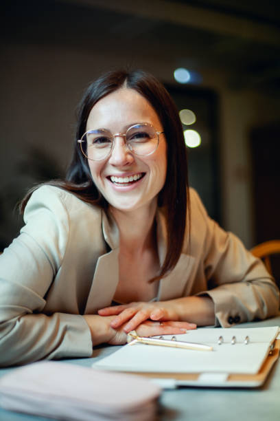 istock Beautiful young woman in suit writing her business plans while drinking coffee on break time 1304351093