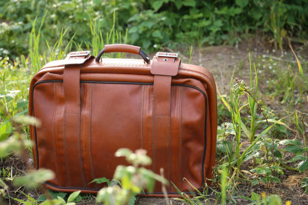 istock Old suitcase on the background of nature 1304352105