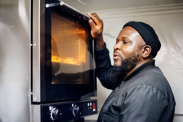 istock African baker checking to see if the croissants are ready 1304352411