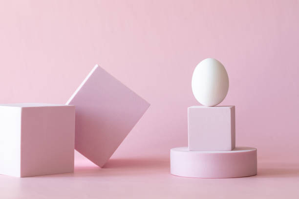 istock Happy Easter greeting card. Pink Podium, stand with white egg. 1304353026