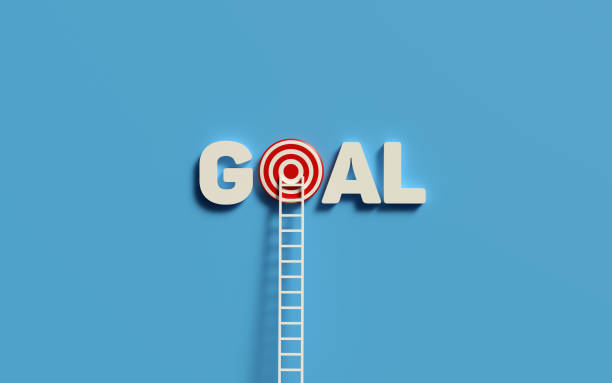istock White Ladder Leaning on target and goal text. 1304353058