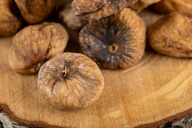 istock Organic dried figs on wood piece 1304353291