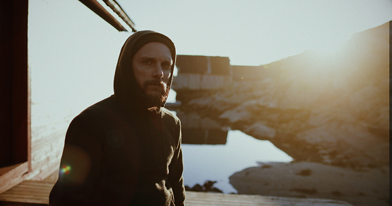 Bearded viking man portrait: by a fjord