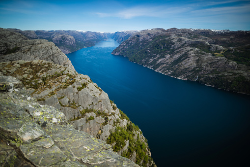 Scenics landmark of Norway: the mountain cliff on Preikestolen over lyse fjord