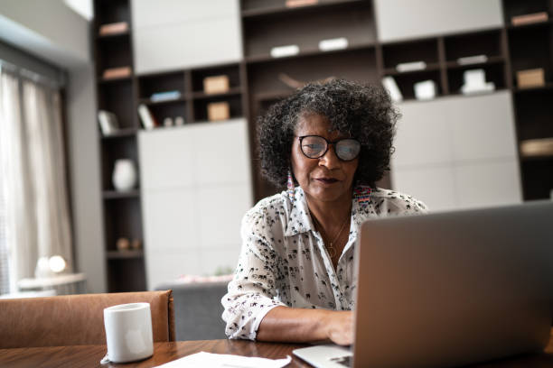 istock Senior woman working from home or using laptop planning or paying bills 1304359933