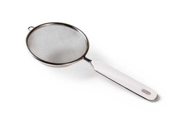 istock Stainless steel tea strainer with hanging ear isolated on white background. Fine mesh sieve with plastic handle close-up. Modern kitchen utensils for food design. Studio shot. 1304360076