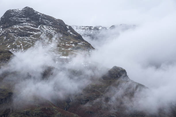 эпический зимний пейзаж изображение зрения от боковой щуки к лангдейл щуки с низким уровнем облаков на горных вершинах и капризный туман з� - harrison stickle стоковые фото и изображения