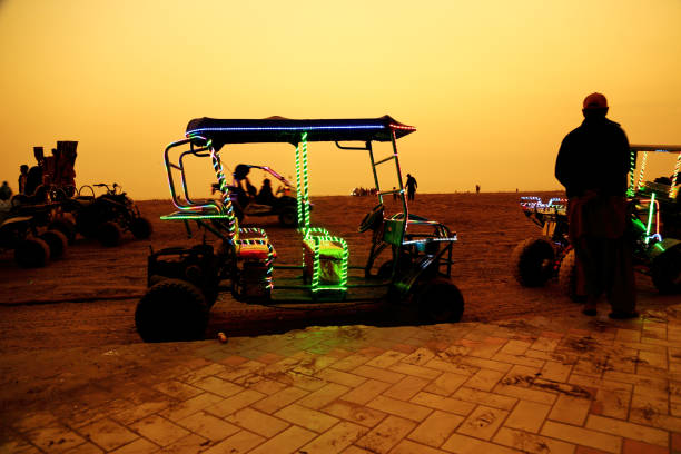 Karachi – Pakistan: Beach goers riding on a locally made beach buggy at Clifton beach