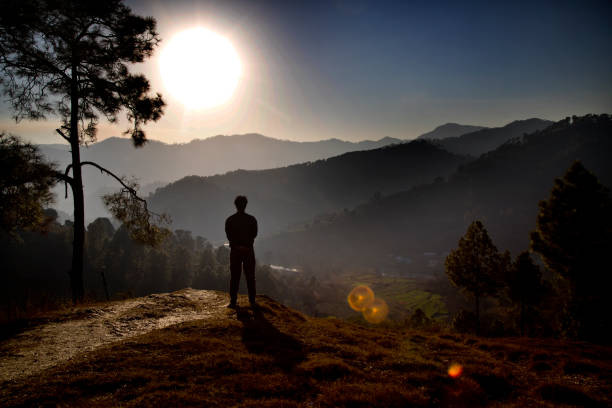 istock Man admiring scenic mountain landscape during sunset 1304361595