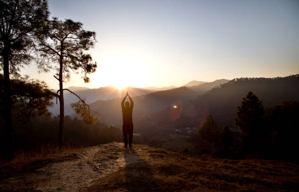 hombre admirando paisaje escénico de montaña durante la puesta del sol - worship place fotografías e imágenes de stock