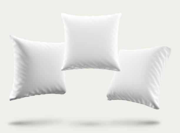 Mockup of three soft and fluffy white cushions with space for a logo, text or image on white background. Realistic 3d render stock photo