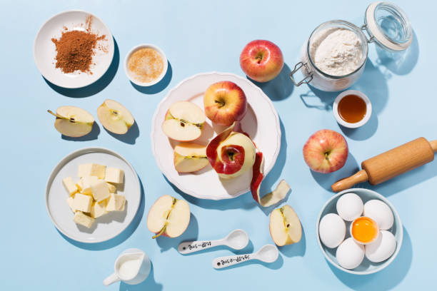 istock Cooking baking background with ingredients, fresh apples, spices and utensils on blue table. 1304367464