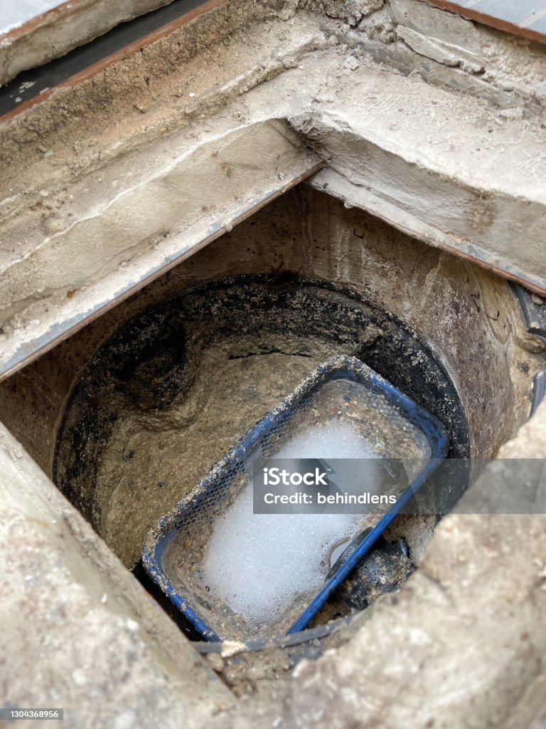 Grease trap plastic box with fatty water floating on top and chemical bubble Grease trap plastic box with fatty water floating on top and chemical bubble. Lubrication Stock Photo