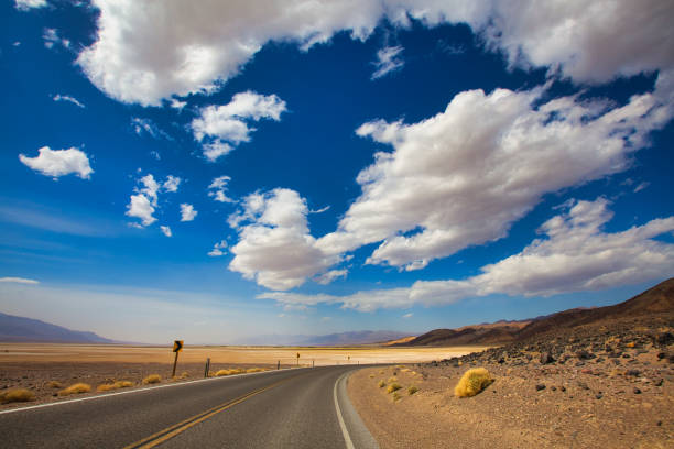 panorama panorâmico da rodovia no meio do deserto - arid climate asphalt barren blue - fotografias e filmes do acervo