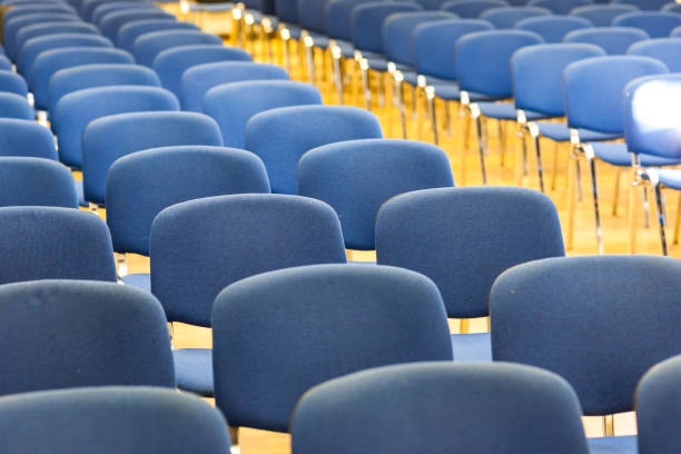 istock Row of Empty Chairs Standing in Line in The Empty Room. Horizontal Image 1304370916