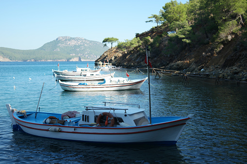 Boats parked on the sea. Beautiful mountains in the background. Picturesque marine landscape.