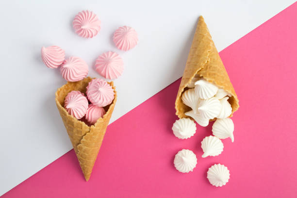 istock Two ice cream cones with white and pink meringue 1304372640