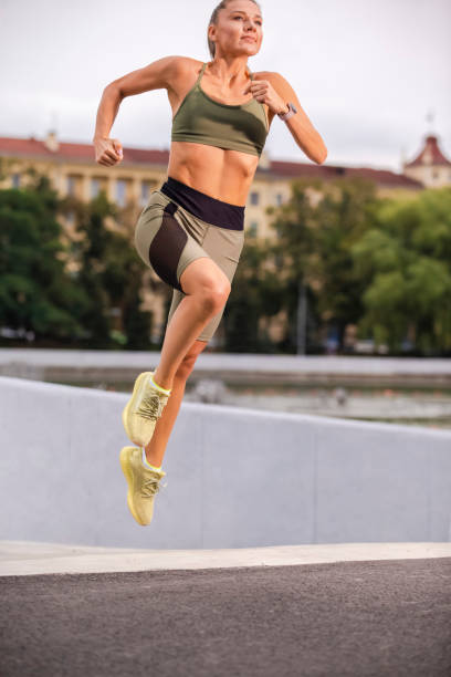 istock Young Female Runner In Jogging Outfit During Her Regular Training Exercises Outdoors. Vertical Shoot 1304373839