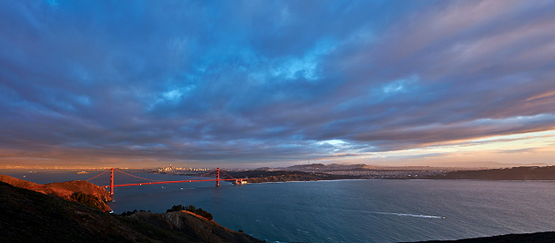 Golden gate bridge and cityscape at dusk dramatic sky, San Francisco, California, USA.