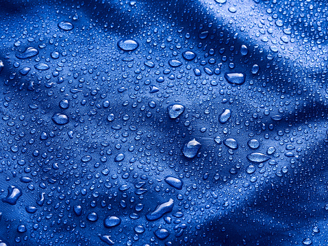 Rain water droplets on waterproof fabric.